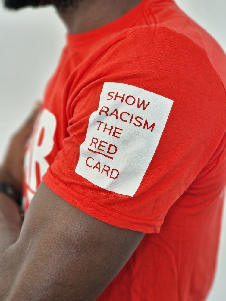 Wear red to show racism the red card | SuperKind